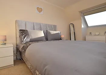 Stylish double bedroom with Smart TV and ample storage space