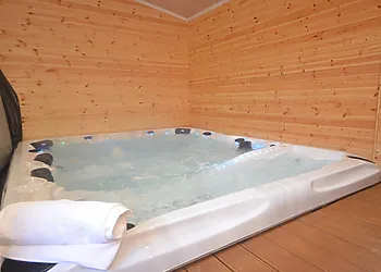 Large sunken hot tub seating 8 people