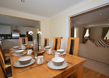Dining area leading to kitchen and lounge