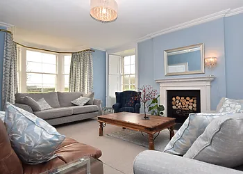 Light and bright lounge with bay window, working shutters, feature fireplace and Smart TV