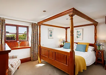 Four-poster double with en-suite with shower over bath 