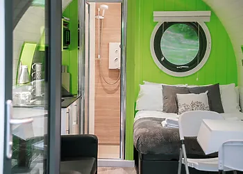 The shower roomwith wash basin and toilet within the pod