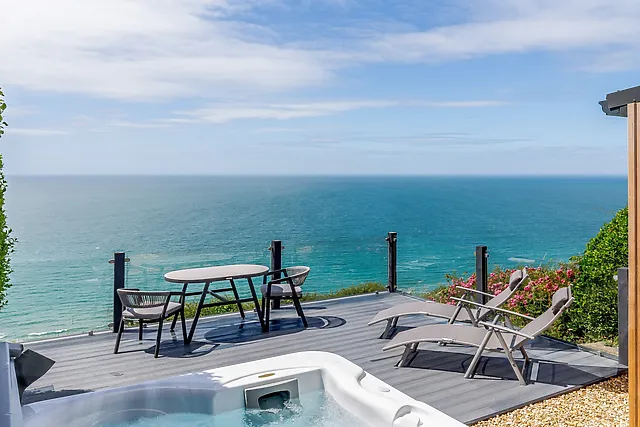 A glass-fronted deck gives this Tregonhawke lodge a 180-degree view of the bay