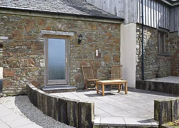 Rear view of the property and patio