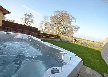 Enjoy the private hot tub with countryside views 
