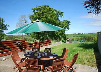 Rear patio area with garden furniture