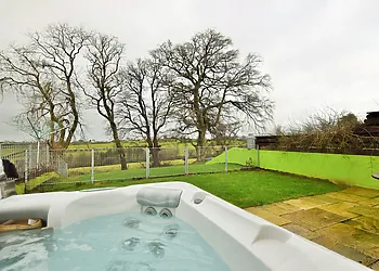 Relax in the hot tub and enjoy the country views from the enclosed garden