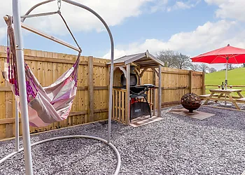 Garden with hammock, fire pit, BBQ and table overlooking the fields