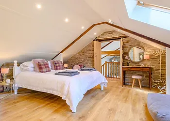 The master bedroom with a king-size bed and an en-suite bathroom