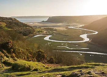 Explore Three Cliffs Bay with its wonderful views and meandering river