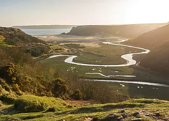 Explore Three Cliffs Bay with its wonderful views and meandering river