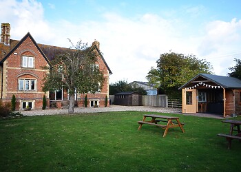 View towards the property, hot tub and garden area