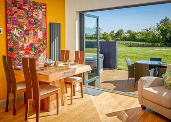 Stylish open-plan living space with bi-fold door to patio 