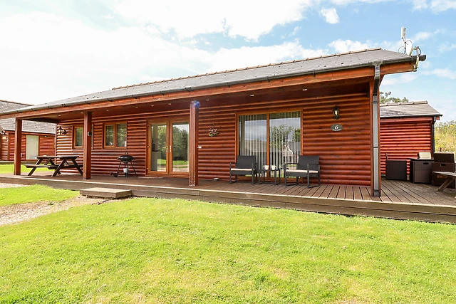 This log cabin near Lincoln has a hot tub on its decking and seven acres of grounds to wander