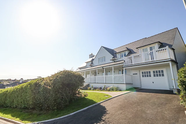 This wood-panelled house sits high above the seaside town, with a hot tub in the garden